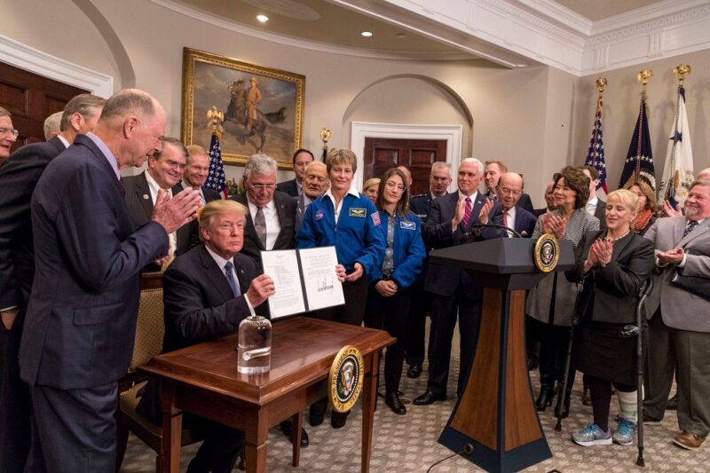 In this file photo from Dec. 11, 2017, President Donald Trump signs Space Policy Directive -1. Official White House photo: Joyce N. Boghosian