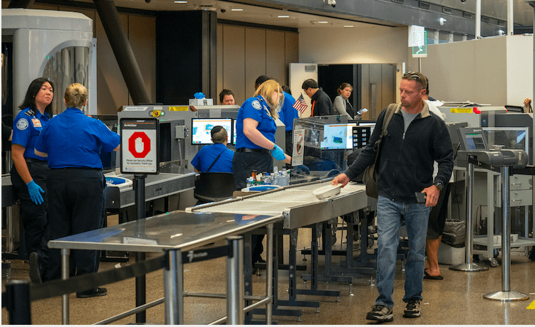 Seattle, WA AUGUST 26, 2018: Man passes though Transportation Security Administration TSA security checkpoint at Seattle-Tacoma International Airport. (Seattle, WA AUGUST 26, 2018: Man passes though Transportation Security Administration TSA security